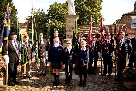 Children stood by the statue